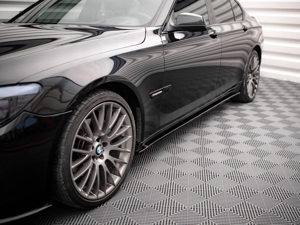 Maxton Design BMW 7 Series F01 M-Pack side skirts and diffusers in black, showing detailed aerodynamic styling and fitment.