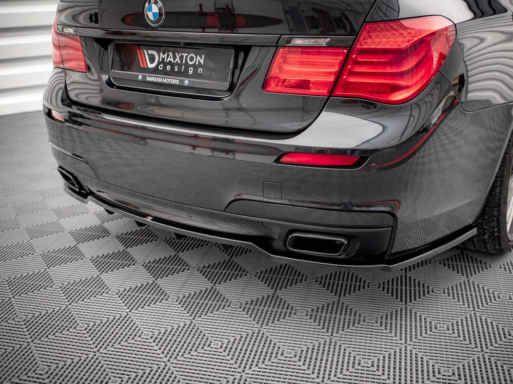Maxton Design rear splitter with vertical bars for BMW 7 Series F01 M-Pack, showcasing black aerodynamic styling.