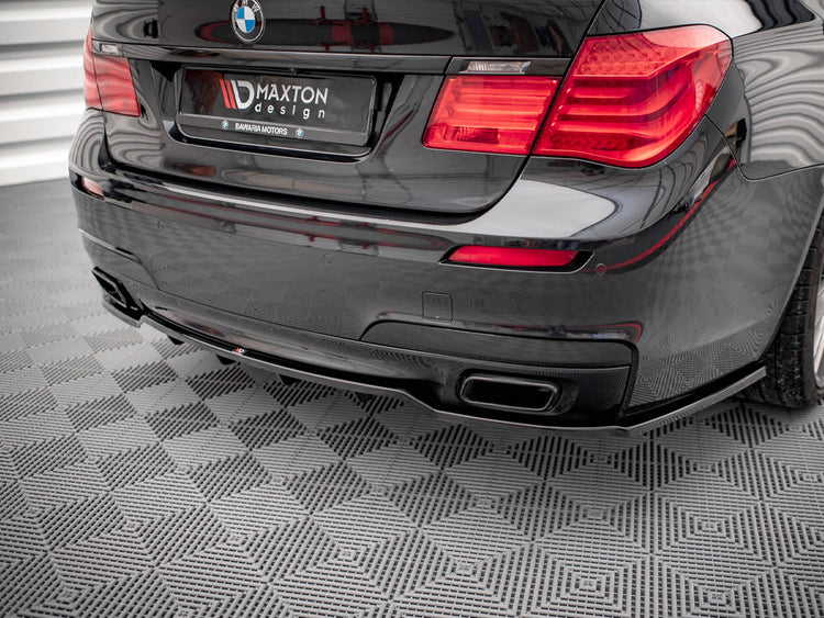 Maxton Design rear splitter with vertical bars for BMW 7 Series F01 M-Pack, showcasing black aerodynamic styling.