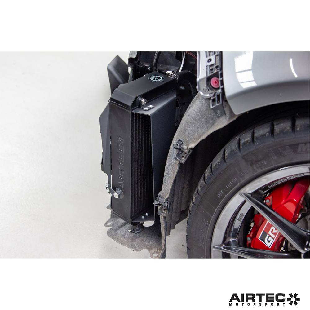 AIRTEC Motorsport gearbox oil cooler installed in a Toyota Yaris GR Gen 2 automatic transmission, showcasing the cooling unit.