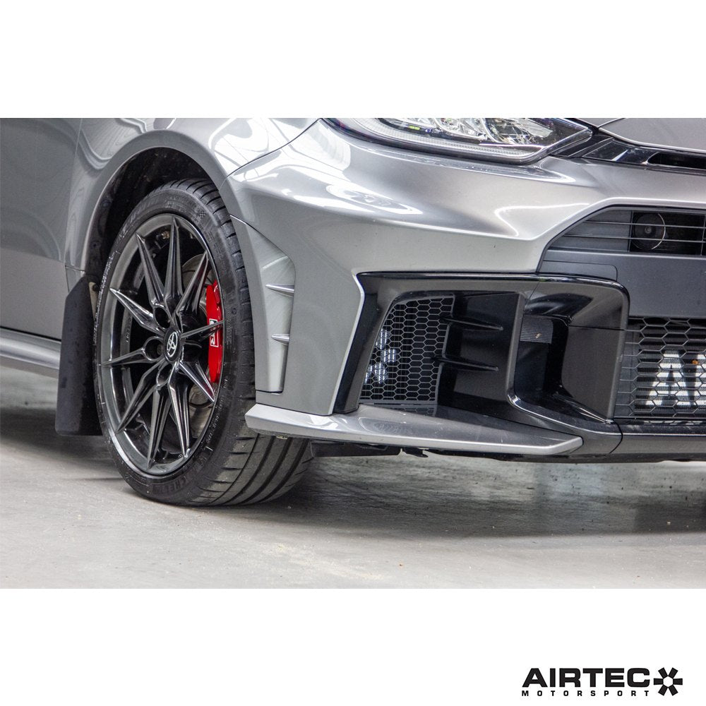 AIRTEC Motorsport auxiliary radiator installed in a Toyota Yaris GR Gen2, showing the compact cooling component and mounting details.