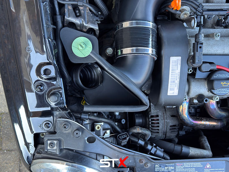 SprogTech STX AVY V2 enclosed intake kit for VW Lupo 1.4 and 1.6 GTI, shown installed with sleek body styling.