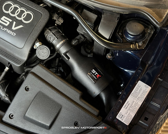 SprogTech STX BAM enclosed intake kit for VAG 1.8T engine, shown installed on a vehicle with body and styling components