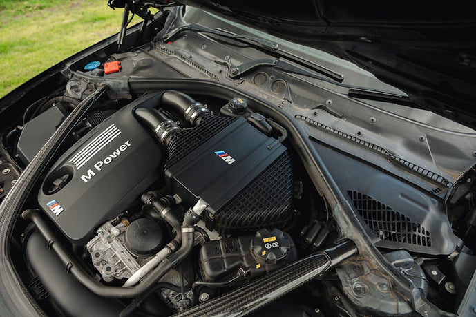 Sprogley Motorsport S55 Charge Cooler Cover in body and styling, showcasing the sleek black design with branding details.