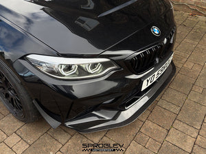 Sprogley Motorsport front bumper canards for F87 BMW M2, aerodynamic body styling accessories on a black car.