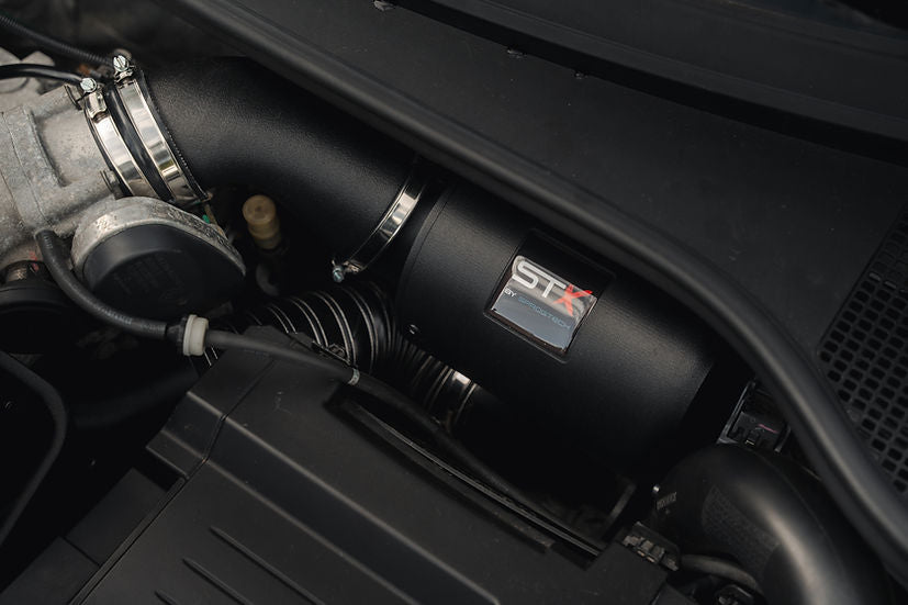 SprogTech STX F4R enclosed intake kit installed on a Clio RS197 and RS200, showing sleek body and styling components.
