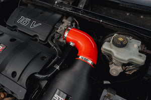 SprogTech STX TU5 enclosed intake kit installed in a Peugeot 106 or Citroen Saxo, showcasing the engine bay with the intake components.