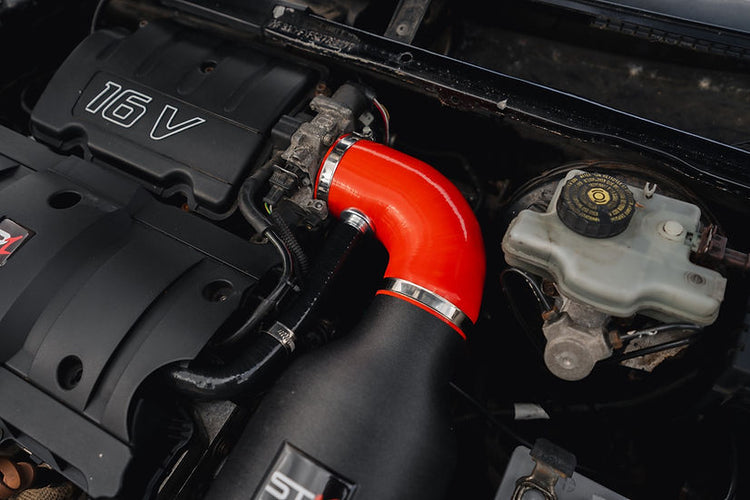 SprogTech STX TU5 enclosed intake kit installed in a Peugeot 106 or Citroen Saxo, showcasing the engine bay with the intake components.